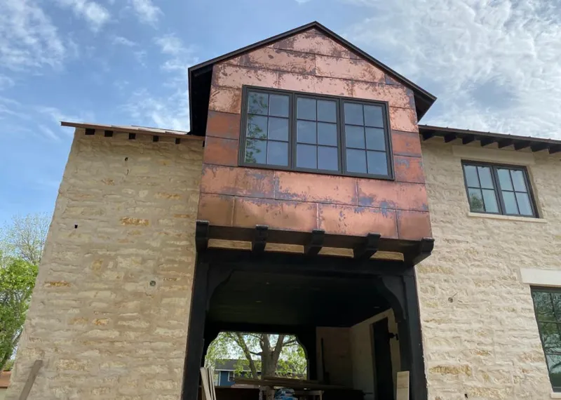 Copper metal panel facade on a stone building for Skylight Installation in Jefferson